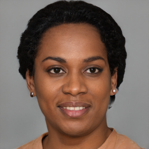 Joyful latino young-adult female with short  black hair and brown eyes