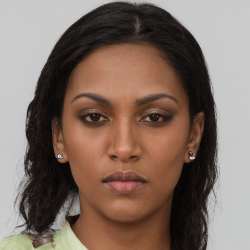 Neutral black young-adult female with long  brown hair and brown eyes