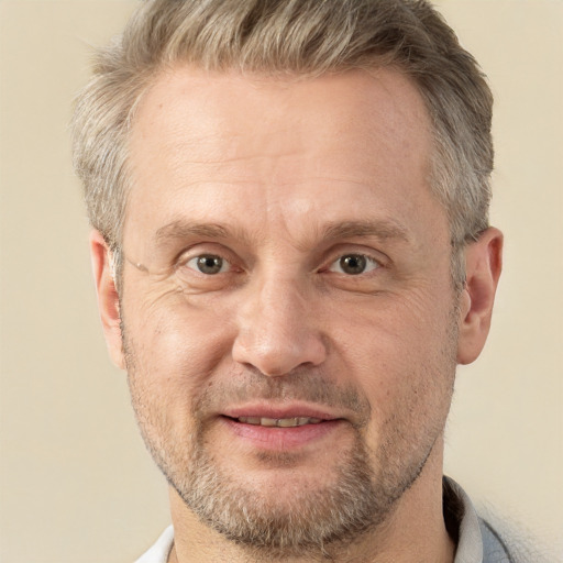 Joyful white middle-aged male with short  brown hair and brown eyes