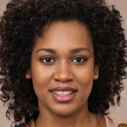 Joyful black young-adult female with medium  brown hair and brown eyes