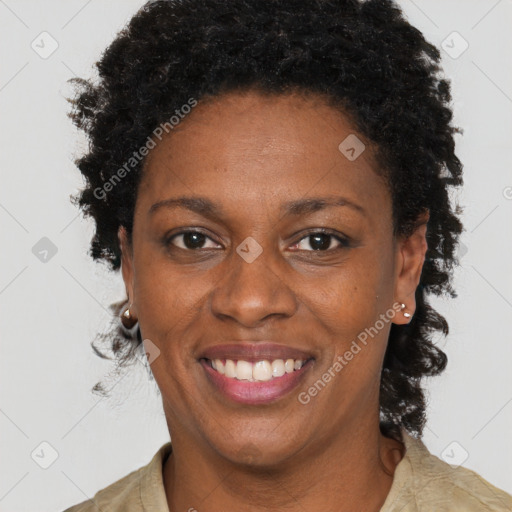 Joyful black adult female with short  brown hair and brown eyes