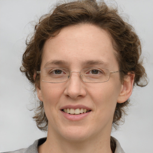 Joyful white adult female with medium  brown hair and grey eyes