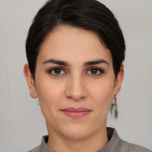 Joyful white young-adult female with short  brown hair and brown eyes