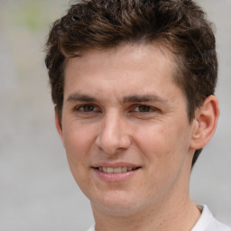 Joyful white adult male with short  brown hair and brown eyes