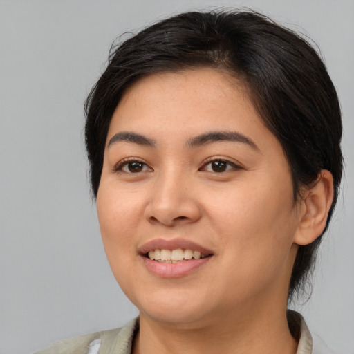 Joyful asian young-adult female with medium  brown hair and brown eyes