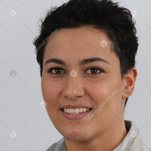 Joyful latino young-adult female with short  brown hair and brown eyes