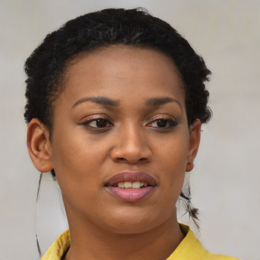 Joyful black young-adult female with short  brown hair and brown eyes