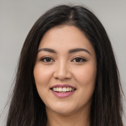 Joyful latino young-adult female with long  brown hair and brown eyes