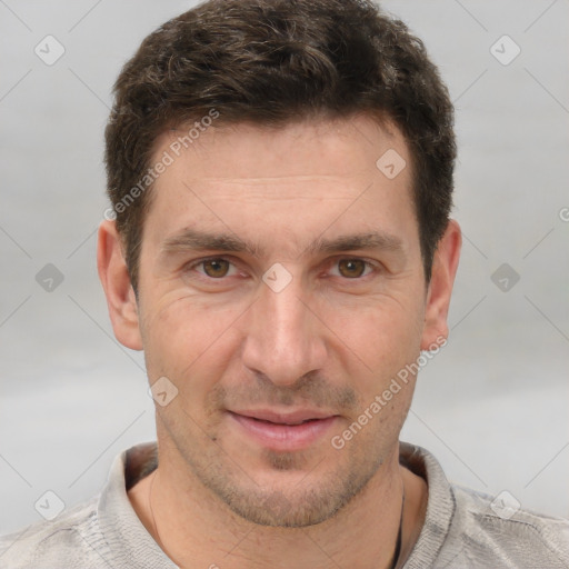 Joyful white adult male with short  brown hair and grey eyes