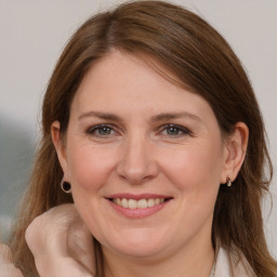 Joyful white adult female with long  brown hair and brown eyes