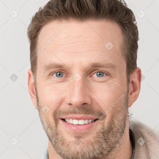 Joyful white adult male with short  brown hair and grey eyes