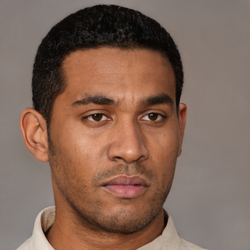 Neutral latino young-adult male with short  black hair and brown eyes