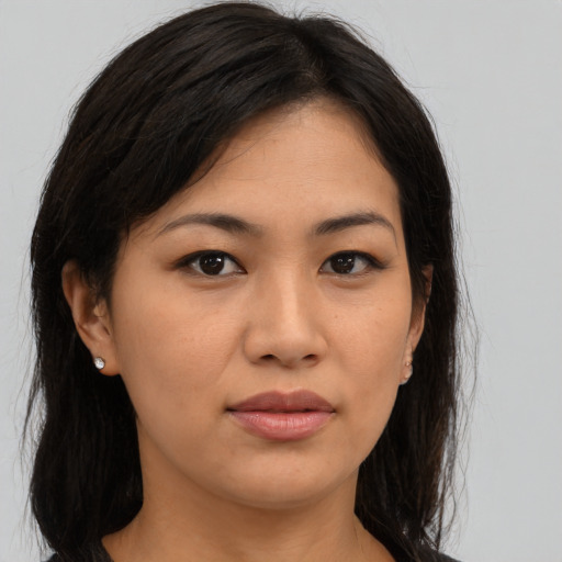 Joyful asian young-adult female with long  brown hair and brown eyes