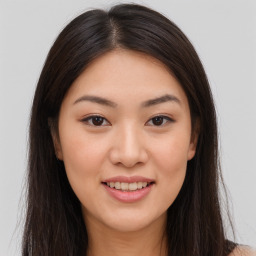 Joyful asian young-adult female with long  brown hair and brown eyes