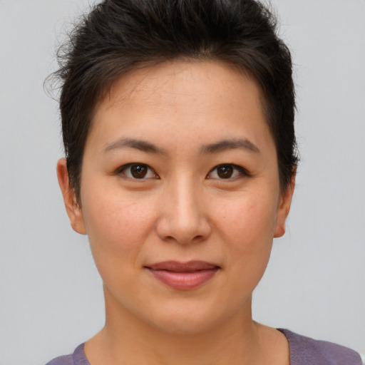 Joyful asian young-adult female with short  brown hair and brown eyes