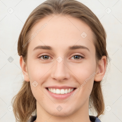 Joyful white young-adult female with medium  brown hair and blue eyes