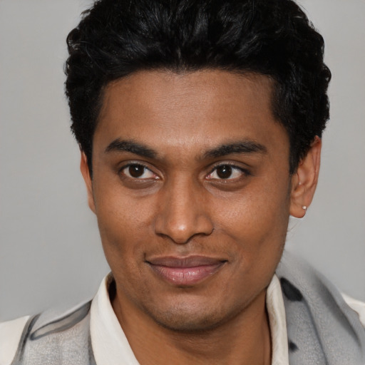 Joyful latino young-adult male with short  black hair and brown eyes