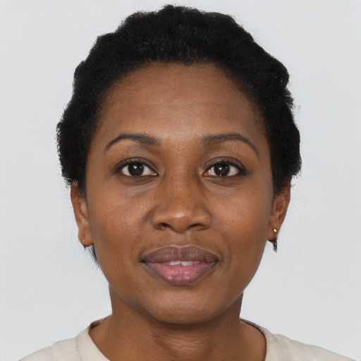 Joyful black adult female with short  black hair and brown eyes