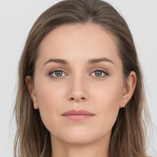 Joyful white young-adult female with long  brown hair and grey eyes