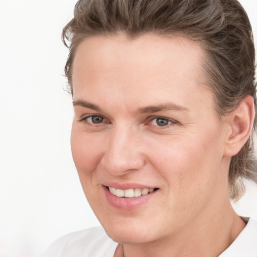 Joyful white young-adult female with medium  brown hair and grey eyes