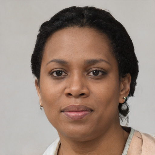 Joyful black young-adult female with short  brown hair and brown eyes