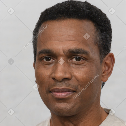 Joyful black adult male with short  black hair and brown eyes