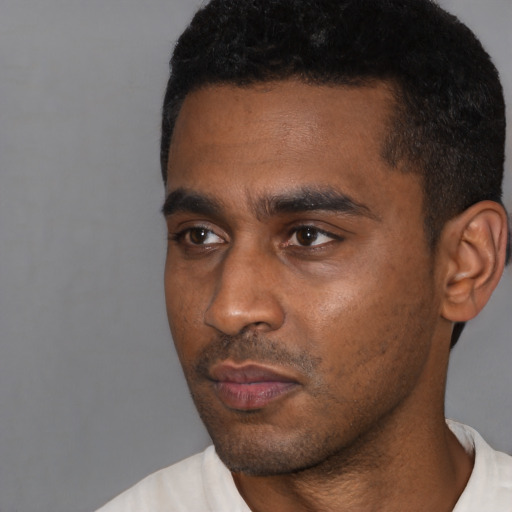 Neutral black young-adult male with short  black hair and brown eyes