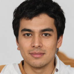 Joyful asian young-adult male with short  brown hair and brown eyes