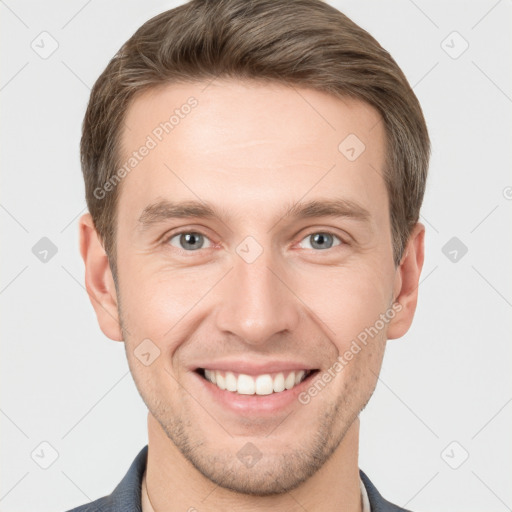 Joyful white young-adult male with short  brown hair and grey eyes