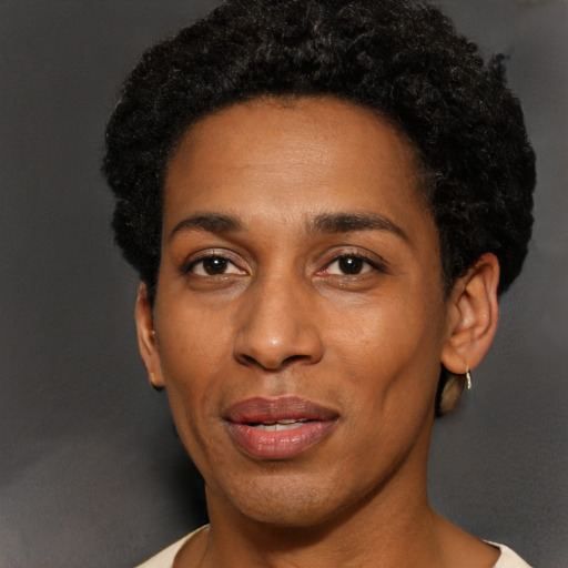 Joyful black young-adult female with short  black hair and brown eyes