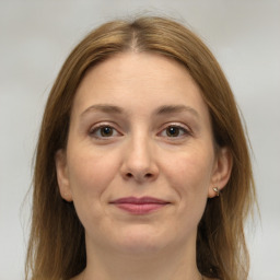 Joyful white adult female with medium  brown hair and grey eyes