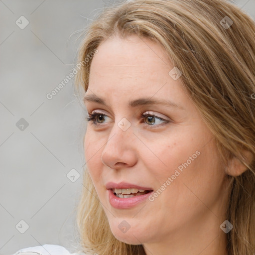 Joyful white adult female with long  brown hair and brown eyes