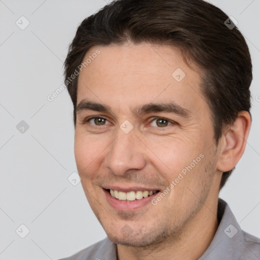 Joyful white adult male with short  brown hair and brown eyes