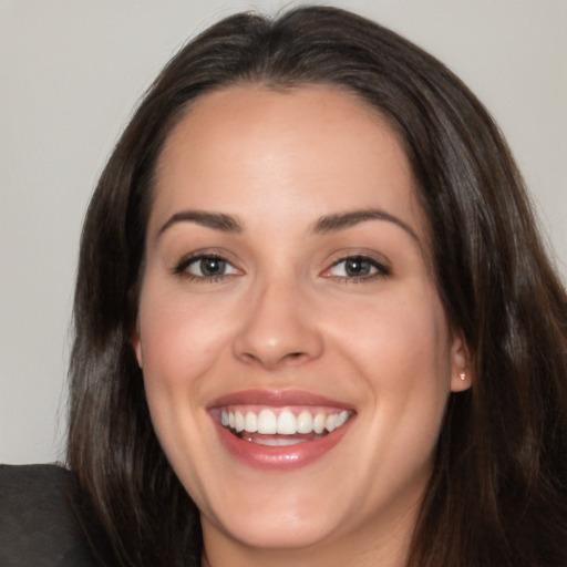 Joyful white young-adult female with long  brown hair and brown eyes