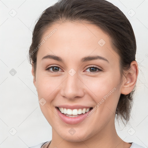 Joyful white young-adult female with medium  brown hair and grey eyes