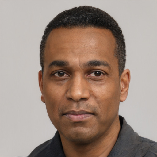 Neutral latino adult male with short  black hair and brown eyes