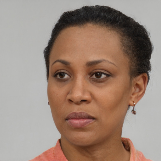 Joyful black adult female with short  brown hair and brown eyes