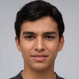 Joyful white young-adult male with short  black hair and brown eyes