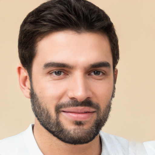 Joyful white young-adult male with short  black hair and brown eyes