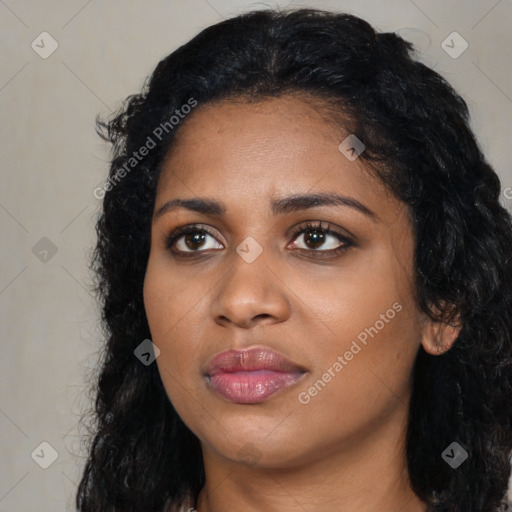 Joyful black young-adult female with long  black hair and brown eyes