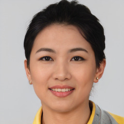 Joyful asian young-adult female with short  black hair and brown eyes