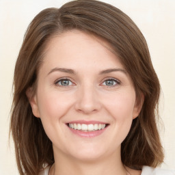 Joyful white young-adult female with medium  brown hair and green eyes