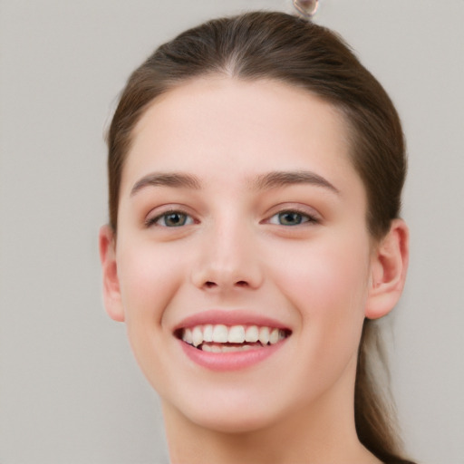 Joyful white young-adult female with long  brown hair and grey eyes