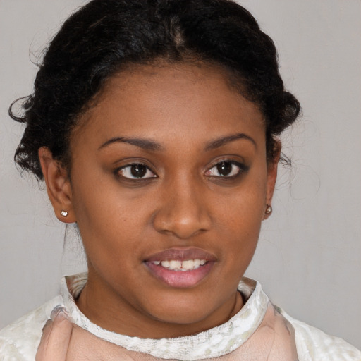 Joyful black young-adult female with short  brown hair and brown eyes