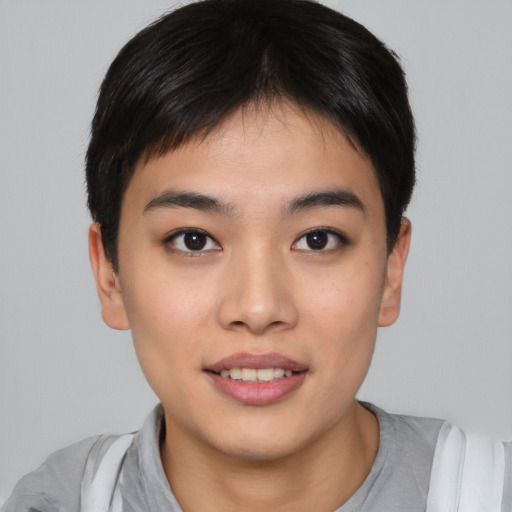 Joyful asian young-adult female with short  brown hair and brown eyes