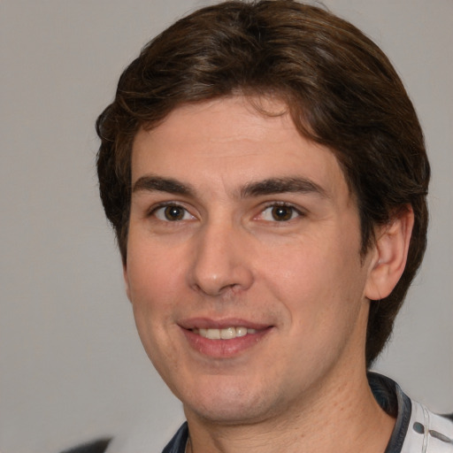 Joyful white young-adult male with medium  brown hair and brown eyes