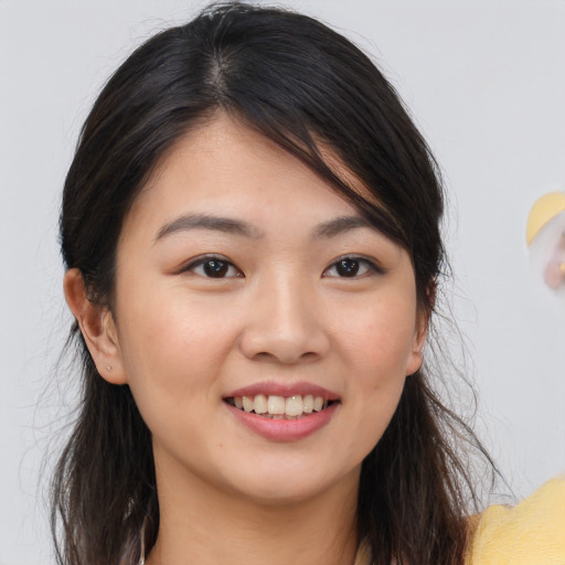 Joyful white young-adult female with long  brown hair and brown eyes