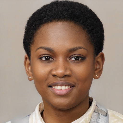 Joyful black young-adult female with short  black hair and brown eyes