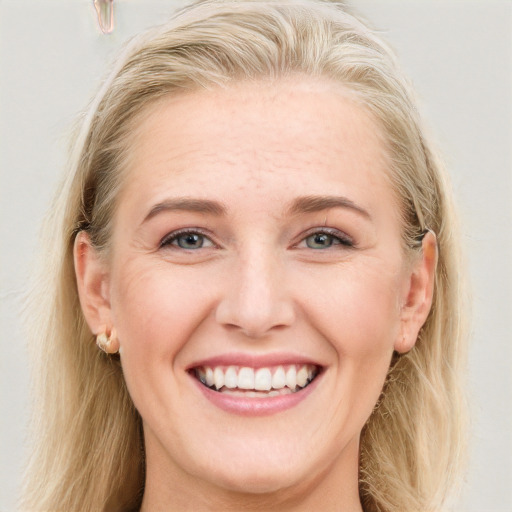 Joyful white young-adult female with long  brown hair and blue eyes