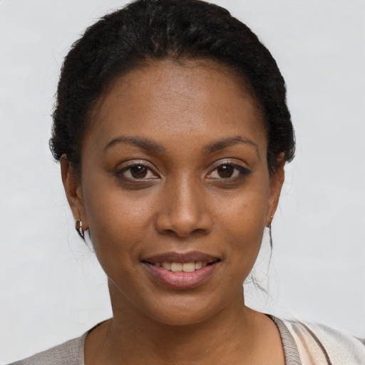 Joyful black young-adult female with short  brown hair and brown eyes